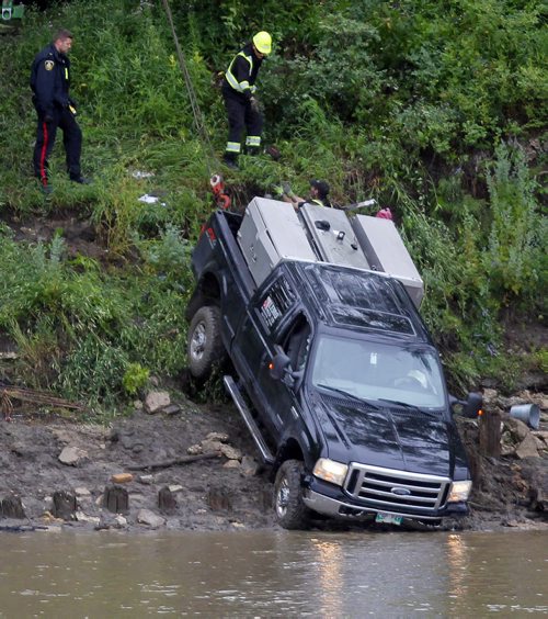 BORIS MINKEVICH / WINNIPEG FREE PRESS NEWS - A commercial welding truck owned by Lemo Mechanical Ltd. gets winched out of the Red River on Tache Ave. near Messager Street. No other info. July 13, 2016