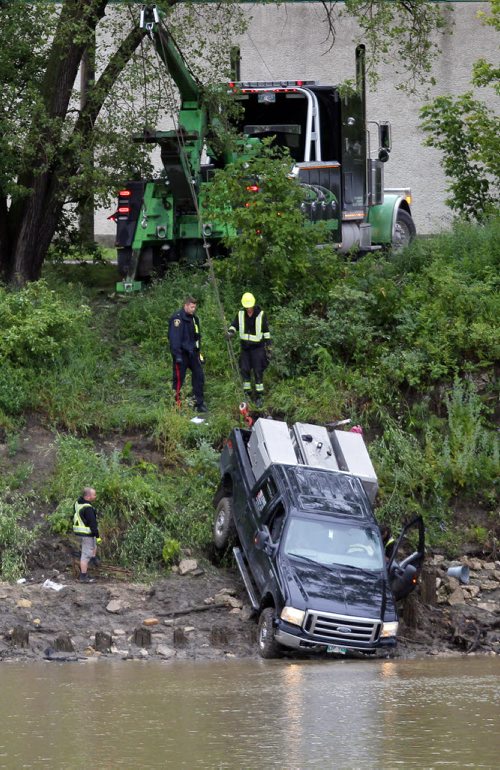 BORIS MINKEVICH / WINNIPEG FREE PRESS NEWS - A commercial welding truck owned by Lemo Mechanical Ltd. gets winched out of the Red River on Tache Ave. near Messager Street. No other info. July 13, 2016