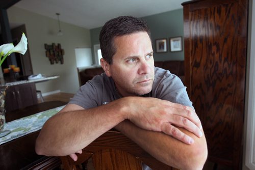 JOE BRYKSA / WINNIPEG FREE PRESS  Kevin Martin, a Winnipeg paramedic currently on leave with PTSD based on horrible awful things he witnessed at a murder scene last month- poses for a photograph in his home-July 13, 2016-(See Mike McIntyre story)