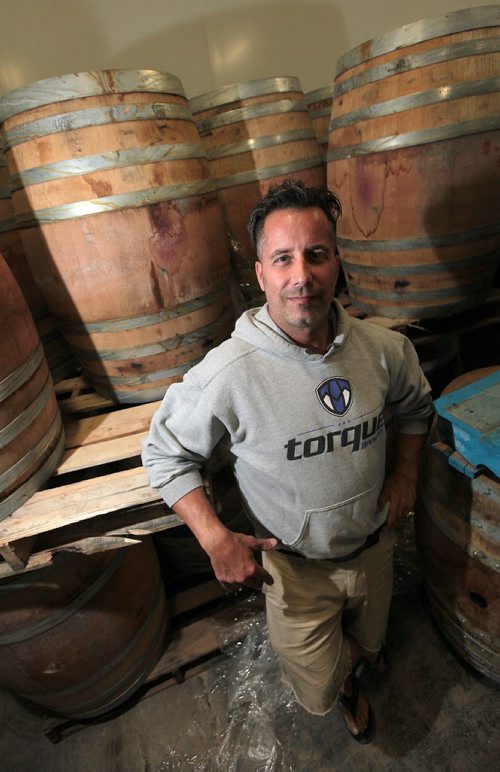 PHIL HOSSACK / WINNIPEG FREE PRESS -  John Heim poses with wine barrels used to age "Sour" beer which will sell at a premium after aging for months or years. . See Ben McPhee Sigurdson's Story.    July 13, 2016