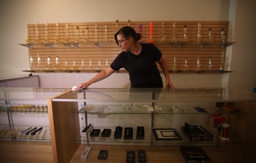RUTH BONNEVILLE / WINNIPEG FREE PRESS  Weeds Glass and Gifts - 52 Adelaide  Newly opened Pot Shop by owners from BC located in the Exchange District - not following Health Canada's procedure.   Salesperson Julie Weisshaar dusts glass wear  in store Thursday.   See Bailey hildebrand-Russell story.   July 14, 2016