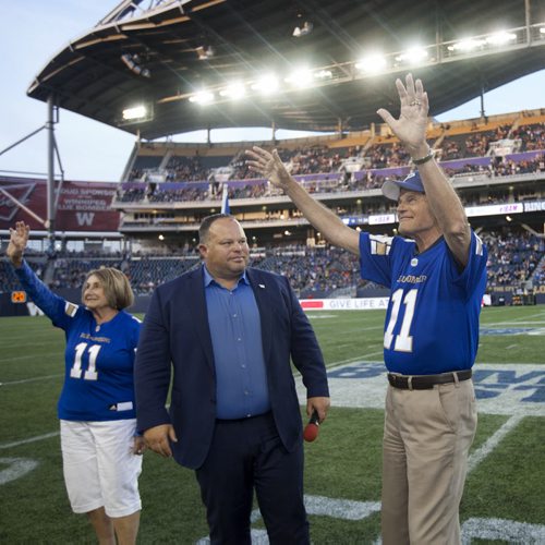 RUTH BONNEVILLE / WINNIPEG FREE PRESS  All-star quarterback Ken Ploen who started with The Winnipeg Blue Bombers in 1957,  was inducted into the Ring of Honour during halftime  with Bomber CEO Wade Miller and his wife Janet at Bomber hosting Eskimos game at Investors Group Stadium Thursday night.    July 14, 2016