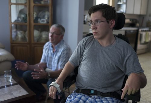 ZACHARY PRONG / WINNIPEG FREE PRESS  Luke Savoie and his father Joseph at their home in Winnipeg. Luke has been testing a new technology called HANA (Home Access Network Assistant) that allows people with handicaps to control things like lights, doors and the TV with voice commands. July 14, 2016.
