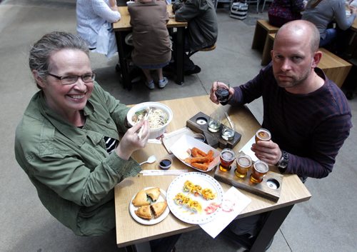 BORIS MINKEVICH / WINNIPEG FREE PRESS (L-R) Winnipeg Free Press food writer Alison Gillmor and Winnipeg Free Press's Ben MacPhee-Sigurdson, who writes about wine, beer and spirits, test out The Common at the Forks. July 12, 2016