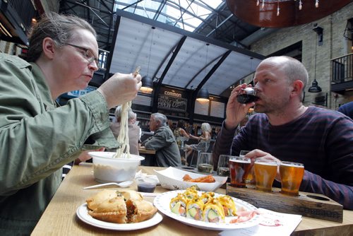 BORIS MINKEVICH / WINNIPEG FREE PRESS (L-R) Winnipeg Free Press food writer Alison Gillmor and Winnipeg Free Press's Ben MacPhee-Sigurdson, who writes about wine, beer and spirits, test out The Common at the Forks. July 12, 2016