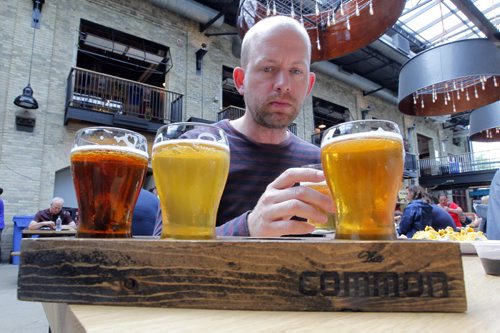 BORIS MINKEVICH / WINNIPEG FREE PRESS Winnipeg Free Press's Ben MacPhee-Sigurdson tests out some beer at The Common located in The Forks. July 12, 2016