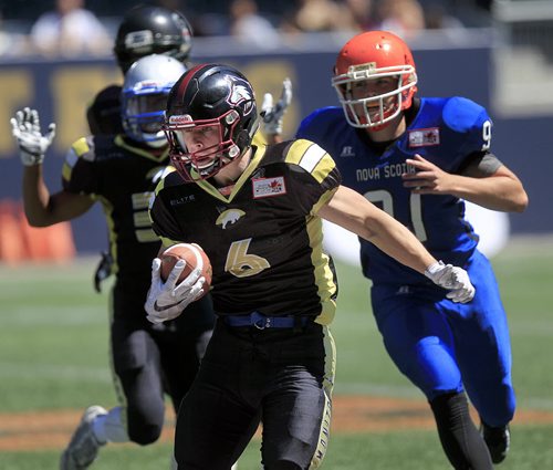 PHIL HOSSACK / WINNIPEG FREE PRESS -   Manitoba Gold receiver #6 Kaeden Corrie scrambles around the Nova Scotia defensive line at the Canada Cup football match between the Manitoba Gold Team and Nova Scotia. Scott Billeck story.  See story. July 15, 2016