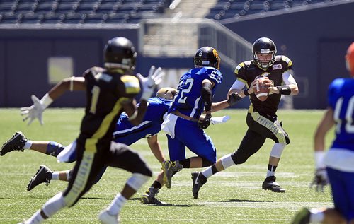 PHIL HOSSACK / WINNIPEG FREE PRESS -   Manitoba Gold QB Adreas Dueck #11 scrambles around the Nova Scotia defence at the Canada Cup football match between the Manitoba Gold Team and Nova Scotia. Scott Billeck story.  See story. July 15, 2016