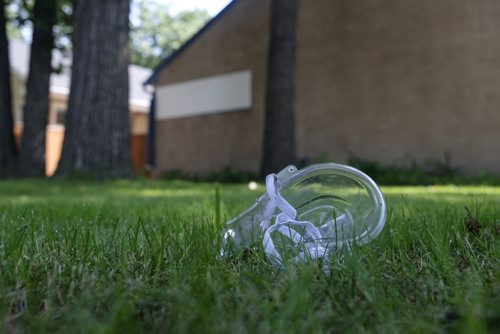 ZACHARY PRONG / WINNIPEG FREE PRESS  An oxygen mask lays on the front lawn of a Fort Garry home that caught fire on the evening of July 15, 2016. Firefighters forced their way into the home and rescued a woman who was taken to the hospital in serious condition. July 16, 2016.