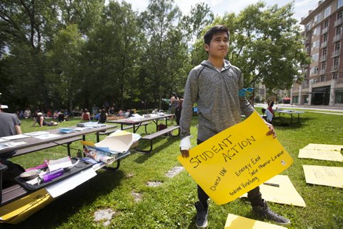 RUTH BONNEVILLE / WINNIPEG FREE PRESS  Sixteen-year-old Rainer Bunn From Shoal Lake 40 First Nation holds a poster made by organizers for a 13 Fires event at Steven Juba Park to  discuss  the water issues facing the reserve Saturday.    See Alex Paul story.   July 16, 2016