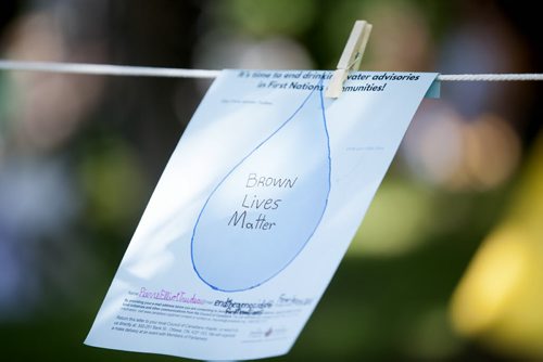 RUTH BONNEVILLE / WINNIPEG FREE PRESS  The "Reflects in Water" art installation, combines statements from people living in Shoal Lake 40 hanging on lines in Steven Juba Park Saturday for and event  to  discuss  the water issues facing his reserve Saturday.    See Alex Paul story.   July 16, 2016