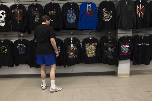 ZACHARY PRONG / WINNIPEG FREE PRESS  A customer browses for T-shirts at O Calcutta. July 16, 2016.