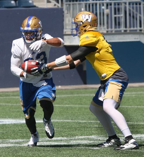 JOE BRYKSA / WINNIPEG FREE PRESS  Bombers head Andrew Harris, left, gets a handoff from Drew WIlly at practice Monday at IGF Field. Winnipeg Blue Bombers are in preparation for a home game this Thursday against the Calgary Stampeders  - July 18, 2016 -(See Jeff Hamiltonstory)