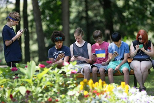 JOE BRYKSA / WINNIPEG FREE PRESSL to R- Evan Thompson, Nate Smith, Mike Hodges, Brandt Burdeniuk, Tommy Jung, Erin Woodplay Pokemon Go in St Vital Park Monday after it was officially released in Canada on Sunday- July 18, 2016 -(Standup photo)