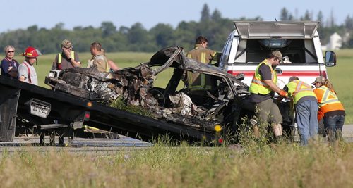 WAYNE GLOWACKI / WINNIPEG FREE PRESS    A burnt vehicle is taken away from the collision scene involving a semitrailer on Highway 6 near Grosse Isle  Monday morning. The crash closed the section on Highway 6 between Highways 67 and 322. July 18 2016
