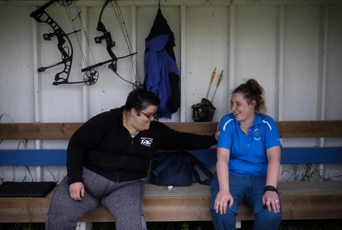 ZACHARY PRONG / WINNIPEG FREE PRESS  Fran Messina, left, and Danielle Arcand, members of the St. Sebastianette Archery Club, take shelter from the rain. June 29, 2016.