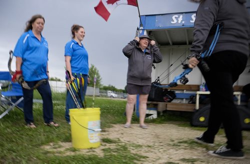 ZACHARY PRONG / WINNIPEG FREE PRESS  From left to right, Charmaine Thienpondt, Danielle Arcand and Denise Arcand, members of the St. Sebastianette Archery Club, shooting on a rainy day. June 29, 2016.