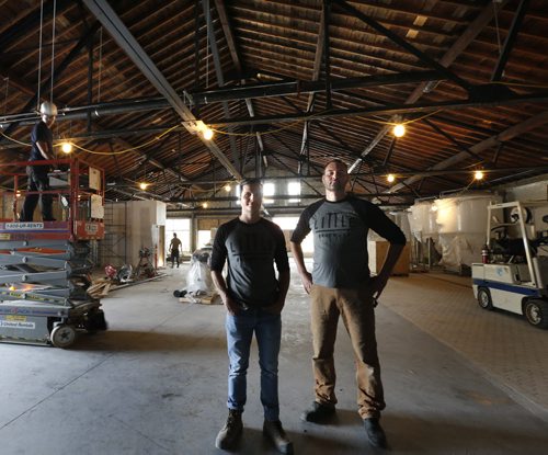 WAYNE GLOWACKI / WINNIPEG FREE PRESS  At left, Kevin Selch the founder of Little Brown Jug Brewing Company and  brewmaster Bernhard Wieland in their new brewery under construction on William Ave. Ben MacPhee-Sigurdson¤story     July 19 2016