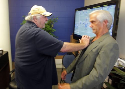 BORIS MINKEVICH / WINNIPEG FREE PRESS Bomber Veteran offensive line guru Bob Wylie, is also a magician. This is for a Wiecek column. Photos shot in his office at IGF. In this photo Bob shows Paul some moves. July 19, 2016