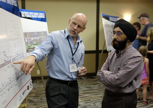 ZACHARY PRONG / WINNIPEG FREE PRESS  Kelly Van Camp, an engineer with Hatch, a company working on the Southwest Rapid Transitway, talks to Sital (last name not given) about newly unveiled plans for the city's first transit corridor. Citizens and City staff gathered at the Canada Inns Fort Garry on Pembina Highway for an information session on Stage 2 the project. July 19, 2016.