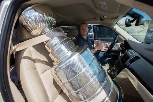 MIKE DEAL / WINNIPEG FREE PRESS Pittsburgh Penguins forward Eric Fehr gets behind the while of his truck with the cup in the passenger seat after spending the afternoon at the Southland Mall in Winkler, Manitoba posing with fans for photographs with the Stanley Cup. 160720 - Wednesday, July 20, 2016