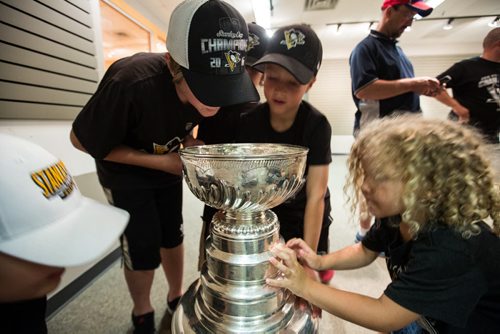 MIKE DEAL / WINNIPEG FREE PRESS Children in the Wiebe and Fehr family gathered at the Southland Mall to check out the Stanley Cup after Penguins Eric Fehr spent the afternoon posing with it in the Mall. Pittsburgh Penguins forward Eric Fehr spent the afternoon at the Southland Mall in Winkler, Manitoba pose with fans for photographs with the Stanley Cup. 160720 - Wednesday, July 20, 2016