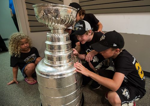 MIKE DEAL / WINNIPEG FREE PRESS Children in the Wiebe and Fehr family gathered at the Southland Mall to check out the Stanley Cup after Penguins Eric Fehr spent the afternoon posing with it in the Mall. Pittsburgh Penguins forward Eric Fehr spent the afternoon at the Southland Mall in Winkler, Manitoba pose with fans for photographs with the Stanley Cup. 160720 - Wednesday, July 20, 2016