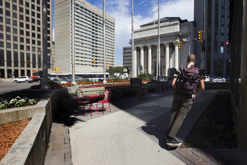 RUTH BONNEVILLE / WINNIPEG FREE PRESS  Photos of the corner of Portage Ave. and Main Street for story on opening the intersection up for pedestrian traffic.   A skateboarder rounds the south west corner of the intersection Wednesday.    July 20, 2016