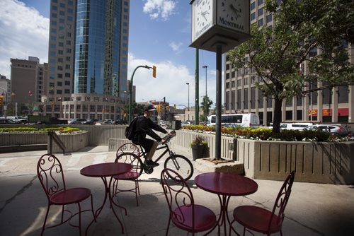 RUTH BONNEVILLE / WINNIPEG FREE PRESS  Photos of the corner of Portage Ave. and Main Street for story on opening the intersection up for pedestrian traffic. A cyclist rounds the south east corner of Portage and Main Wednesday,    July 20, 2016
