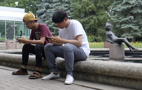 ZACHARY PRONG / WINNIPEG FREE PRESS  Pokemon down. People gathered at the Leo Mol Sculpture Garden at Assiniboine Park only to find the Pokemon Go network had failed. From right to left, Alexis Javier and Ronald Buno. July 20, 2016.