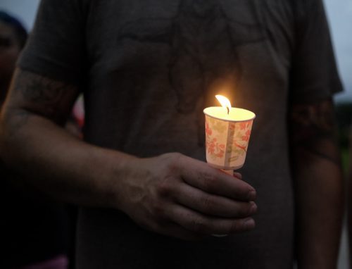 ZACHARY PRONG / WINNIPEG FREE PRESS  A protestor holds a candle at the Legislative Building for a Black Lives Matter Vigil. July 20, 2016.