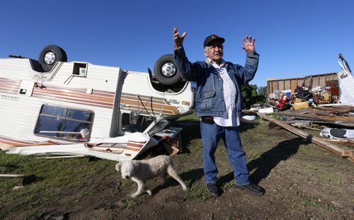 WAYNE GLOWACKI / WINNIPEG FREE PRESS   Clemance Assiniboine with his dog Baby in the back yard of his home on the Long Plain First Nation where sheds at right, his house and motor home were damaged after a tornado touched down Wednesday night. Ashley Prest story  July 21 2016