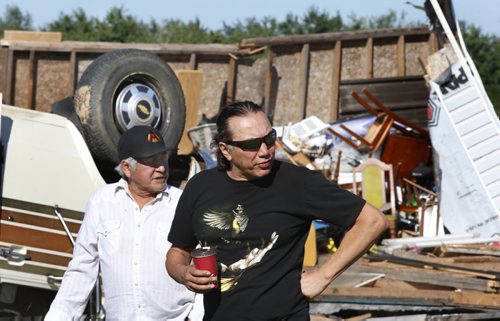 WAYNE GLOWACKI / WINNIPEG FREE PRESS   At right, Chief Dennis Meeches of Long Plain First Nation looks at the damage in  Clemance Assiniboine's yard after a tornado Wednesday night.     Ashley Prest story  July 21 2016