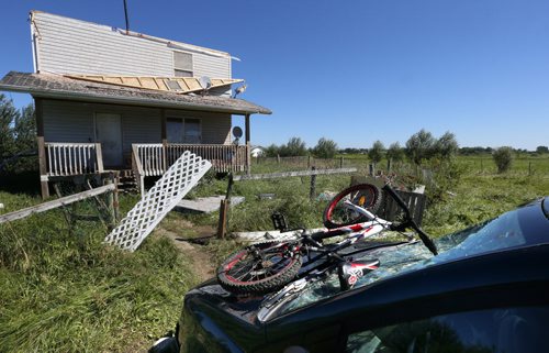 WAYNE GLOWACKI / WINNIPEG FREE PRESS    The home of Edward Houle on the Long Plain First Nation damaged by a tornado that touched down Wednesday night. The roof was lifted off of the house and carried to a nearby field. A bicycle was thrown into the windshield of a van parked in front.   Ashley Prest story  July 21 2016