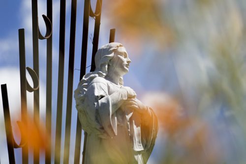 RUTH BONNEVILLE / WINNIPEG FREE PRESS  Statue of Mary through summer flowers.   See Bill Redekop's story on St. Boniface Cemetery.     July 21, 2016