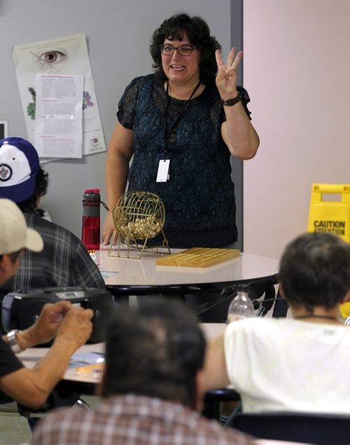 BORIS MINKEVICH / WINNIPEG FREE PRESS VOLUNTEER COLUMN- Shelley Malo volunteers every Thursday evening at Main Street Project. She leads Main Street Project clients in playing recreational bingo. July 21, 2016