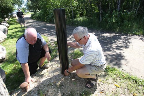 JOE BRYKSA / WINNIPEG FREE PRESS  Gull Lake , Manitoba- Cottagers in area are doing everything they can to prevent zebra mussels from getting into their small lake- Including buying decontamination heat sprayer and installing a gate at the boat launch. - Cottagers  Jim Ritchie, left, and Don Minty by gate that was recently removed by authorities -  July 21, 2016 -(See Bailey Hildebrand-Russell story)