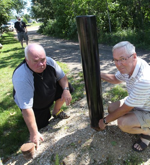 JOE BRYKSA / WINNIPEG FREE PRESS   Gull Lake , Manitoba- Cottagers in area are doing everything they can to prevent zebra mussels from getting into their small lake- Including buying decontamination heat sprayer and installing a gate at the boat launch. - Cottagers  Jim Ritchie, left, and Don Minty by gate that was recently removed by authorities -  July 21, 2016 -(See Bailey Hildebrand-Russell story)
