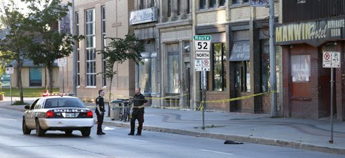 WAYNE GLOWACKI / WINNIPEG FREE PRESS      Winnipeg Police at a¤taped off crime scene in the northbound lanes in the 600 block of Main St. Friday morning.  July 22 2016