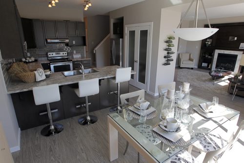 BORIS MINKEVICH / WINNIPEG FREE PRESS HOMES - 59 John Pelland Road in Sage Creek. Contact is Kensington Homes  salesman Rene Giroux. View from the eating area looking at the kitchen, left, and the living room, right.  July 25, 2016