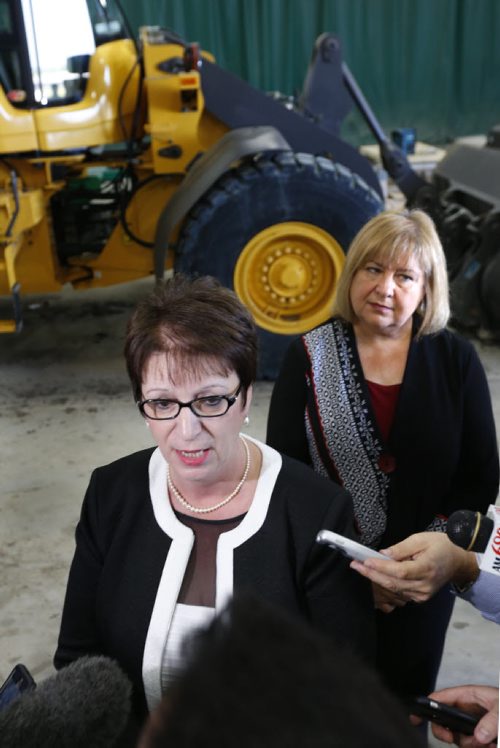 WAYNE GLOWACKI / WINNIPEG FREE PRESS     In the foreground, Eileen Clarke,Indigenous and Municipal Relations Minister and MaryAnn Mihychuk, Employment, Workforce Development and Labour Minister at a municipal infrastructure funding announcement for projects throughout the province. The event held in the Public Works garage in the R.M. West St.Paul Monday  Larry Kusch story  July 25 2016