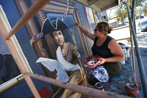 JOHN WOODS / WINNIPEG FREE PRESS Artist, Mandy van Leeuwen, puts the finishing touches to "A Woman's Parliament", a Nellie McClung mural on Sargent at Furby Monday, July 25, 2016. The mural will be officially unveiled tomorrow.