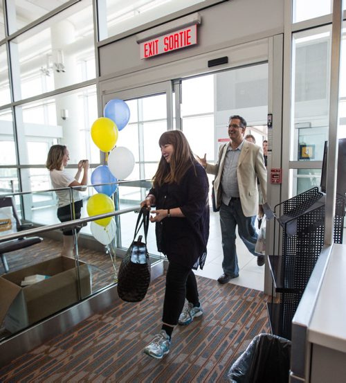MIKE DEAL / WINNIPEG FREE PRESS The first passengers of first plane to arrive at the Winnipeg Richardson International Airport for Newleaf Travel exit the plane. 160725 - Monday, July 25, 2016