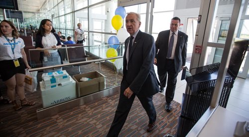 MIKE DEAL / WINNIPEG FREE PRESS Barry Rempel, President and CEO of Winnipeg Airports Authority walks through the gate as the passengers of first plane to arrive at the Winnipeg Richardson International Airport for Newleaf Travel prepare to get off the plane. 160725 - Monday, July 25, 2016