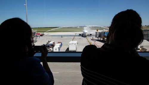 MIKE DEAL / WINNIPEG FREE PRESS As the first plane to arrive at the Winnipeg Richardson International Airport for Newleaf Travel it is greeted with arches of water sprayed from the airports firetrucks as per tradition. 160725 - Monday, July 25, 2016