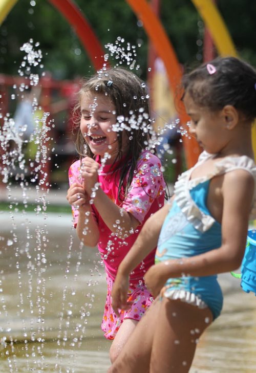 RUTH BONNEVILLE / WINNIPEG FREE PRESS   Five-year-old  Noelle Fuellbrandt (pink) refreshes herself in the cool spray with her friend Sara Ait El Cadi-6yrs  (proper spelling), at Provencher Park Spray Pad Tuesday afternoon.  Standup photo  July 26, 2016