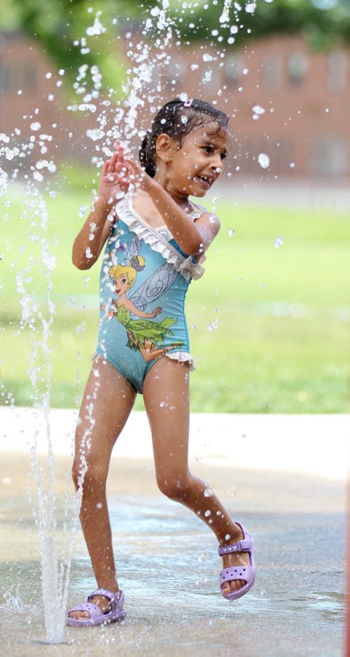 RUTH BONNEVILLE / WINNIPEG FREE PRESS  Six-year-old Sara Ait El Cadi (proper spelling), cools herself in  the sprinklers at Provencher Park Spray Pad Tuesday afternoon while playing with her sisters and friends.   Standup photo  July 26, 2016