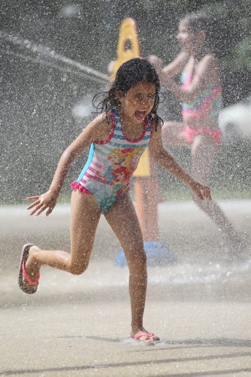 RUTH BONNEVILLE / WINNIPEG FREE PRESS  Five-year-old Arwa Ait El Cadi (proper spelling), cools herself in the sprinklers at Provencher Park Spray Pad Tuesday afternoon while playing with her sisters and friends.   Standup photo  July 26, 2016