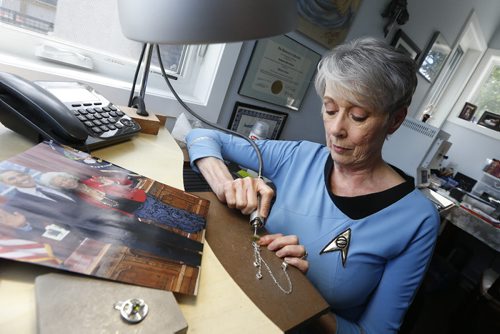 JOHN WOODS / WINNIPEG FREE PRESS Jewellery artist Catherine Kreindler works on some Star Trek jewellery in her home studio Tuesday, July 26, 2016. A photo sits on her desk of Barrack Obama and actress Nichelle Nichols in the Oval Office in 2012. Nichols is wearing one of Kreindler's pieces.