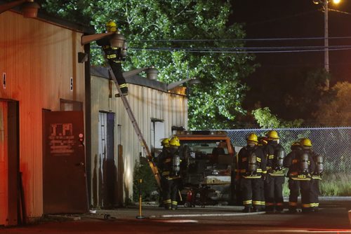 JOHN WOODS / WINNIPEG FREE PRESS Firefighters attend to a fire in an auto body shop on Nairn  Tuesday, July 26, 2016.